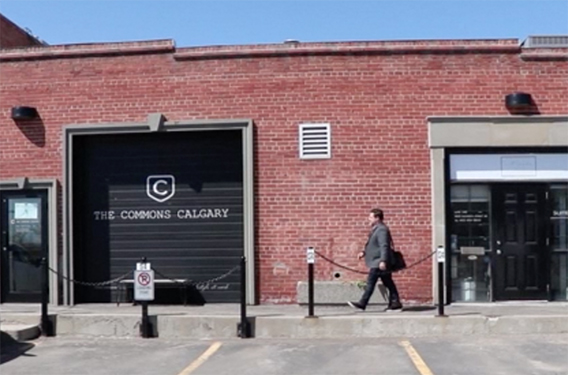 man walking into brick building